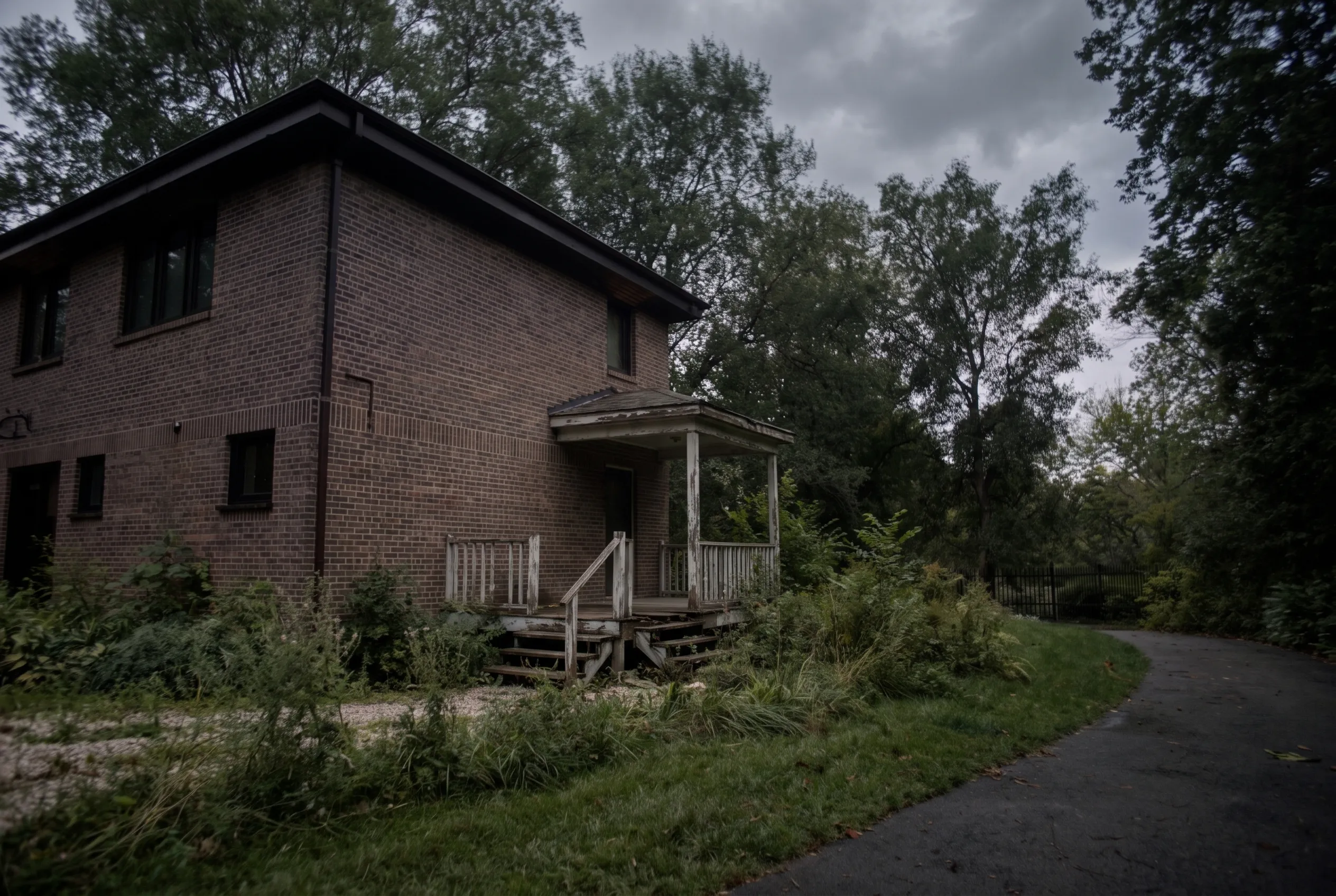 The rear of a 1980s Mississauga two-storey before the addition, with the kitchen backing onto a small deck and the rear wall opened for a steel beam